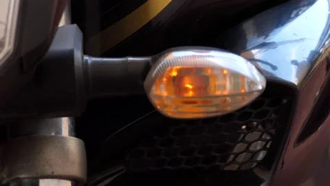 Close shot of a motorcycle blinking and indicating to take a turn Stock Footage 145410627