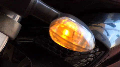 Close shot of a motorcycle blinking and indicating to take a turn Stock Footage 145410667