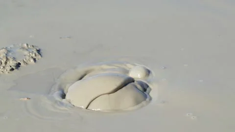 Close up shot of the mud exploding from the earth at the Mud Volcanoes in Stock Footage 134906803