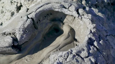 Close up shot of the mud exploding from the earth at the Mud Volcanoes in Stock Footage 134907637