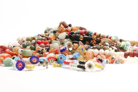 Close Up Shot of Multi Colored Beads Necklace and Bracelet on White Background Stock Photos
