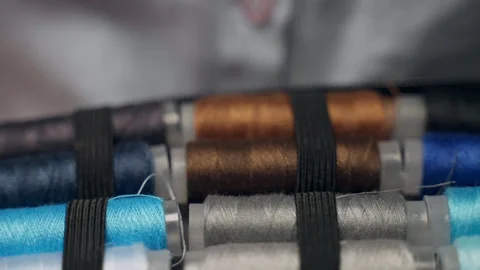 Close-up shot of multicolored thread spools for sewing or repairing clothing Video stock 272165627