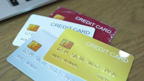 Close-up Shot of Multiple Credit Cards Stacked on Wooden Table. Stock Footage 336717216