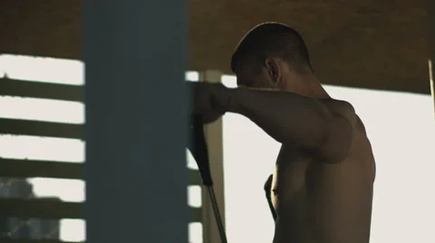 Close shot of a muscular man doing sport in the shadows Video stock 67732855