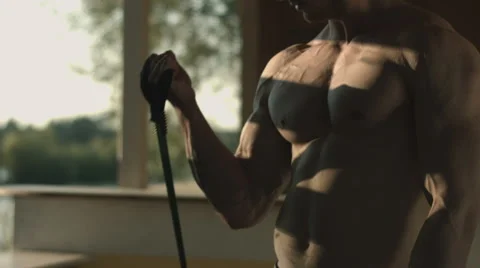 Close shot of a muscular man doing sport in the shadows Stock Footage 67732886