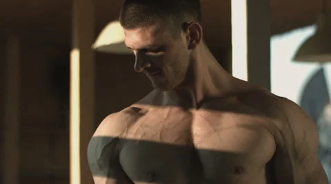 Close shot of a muscular man doing sport in the shadows Stock Footage 67732916