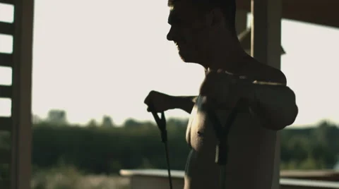 Close shot of a muscular man doing sport in the shadows Stock Footage 67732943