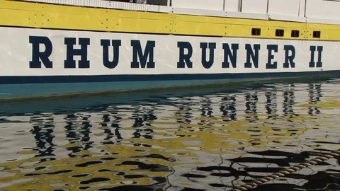 Close shot of name on rum tour boat with reflection on water St George’s Stock Footage 75679843