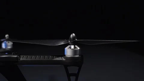Close up shot at night of propeller spin up and stops on a drone Stock Footage 98566099