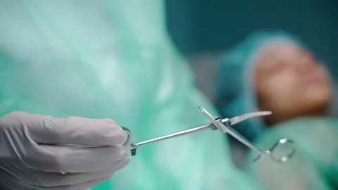 Close-up shot of nurse taking the surgical scissors out of the sterile bag 스톡 동영상 170962053