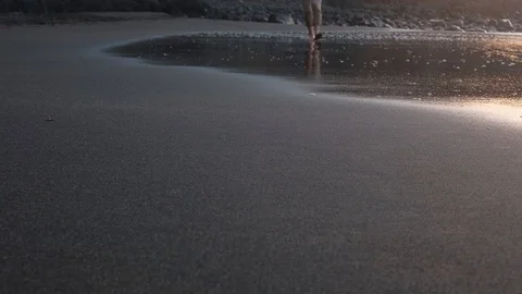 Close up shot of ocean beach sand with alone caucasian barefoot male walking on Stock Footage 123686242