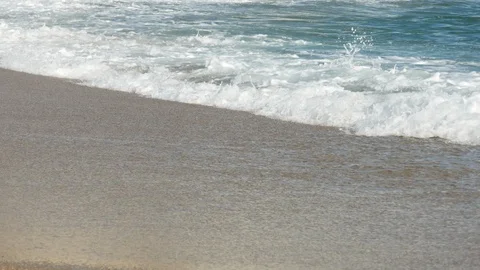 Close up shot of ocean waves lapping on sandy beach, side shot along shoreline Stock Footage 108518161