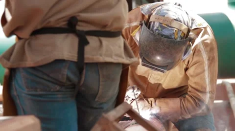 Close Up Shot of  oil and gas workers welding a pipe Stock Footage
