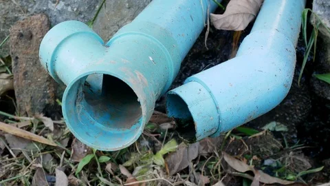 Close up shot of old blue PVC pipes leaking water Stock Footage 113254320