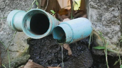 Close up shot of old blue PVC pipes leaking water Stock Footage 113290802
