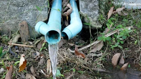 Close up shot of old blue PVC pipes leaking water Stock Footage 113292645