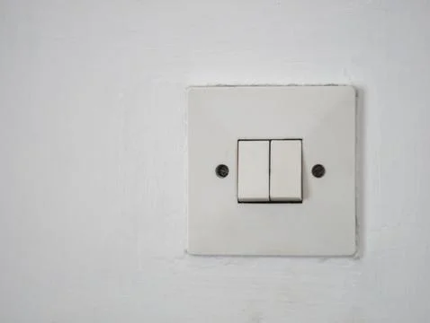 Close-up shot of old double switch for a house light on a white wall Stock Photos