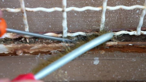 Close up shot of an old gate with weathered corrosion, person removing corroded Video stock 208856467