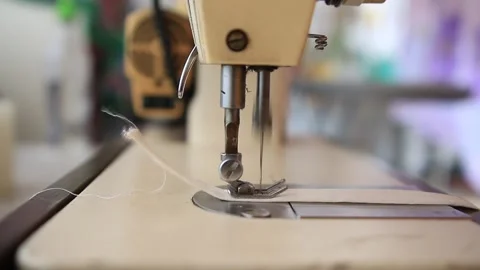 A close up shot from an old sewing machine working on a piece of cloth in southe Stock Footage 264528402