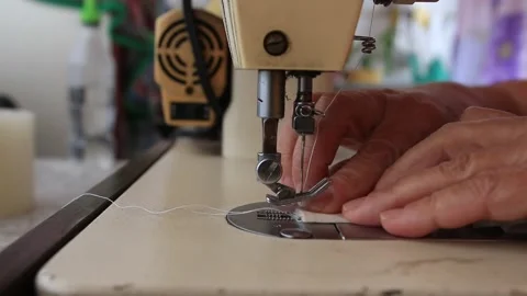 A close up shot from an old sewing machine working on a piece of cloth in southe Stock Footage 264528479