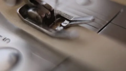 A close up shot from an old sewing machine working on a piece of cloth in southe Stock Footage 264528514