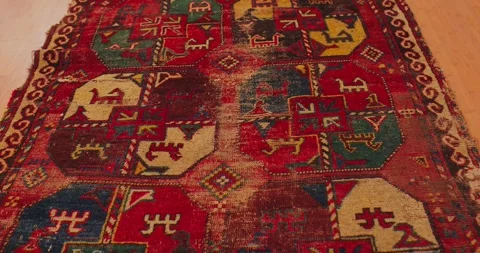 Close up shot of an old shabby handmade carpet made by Samarkand masters using Stock Footage 255481480