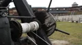 Close-up shot of old wooden catapult detail, tourists at medieval history museum HD Footage