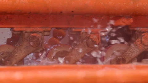 Close Shot of Orange Color Machine Splashing Water in a Factory Slow Motion Stock Footage 166416461
