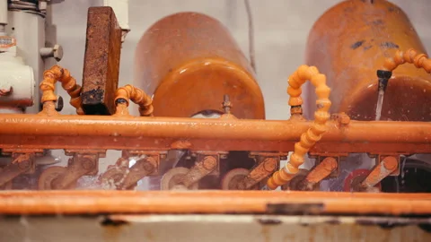 Close Shot of Orange Color Machine Splashing Water in a Factory Slow Motion Stock Footage 166416488