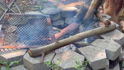Close up shot of outdoor fireplace burning fire and wood with ashes Stock Footage 345020448