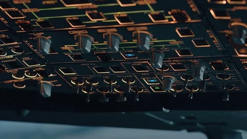 Close shot of overhead panel of modern aircraft with captain's hand switching co Stock Footage 71801823