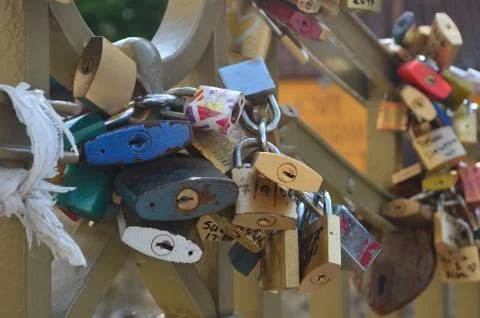 A close-up shot of padlocks on a love-lock bridge. Stock Photos