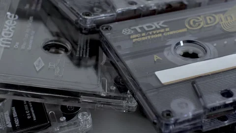 A close up shot panning across a stack of TDK cassette tapes, tapes were a Stock Footage 179964047