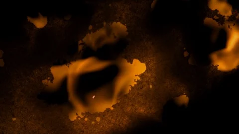 Close up shot of paper burning with fire flames against a black background Vidéo 122176605