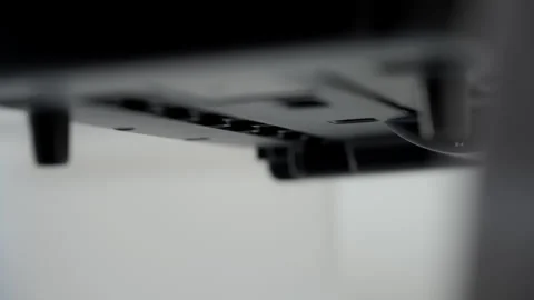 Close up shot of a paper shredder slicing a document into thin strips. Stock Footage 304368302