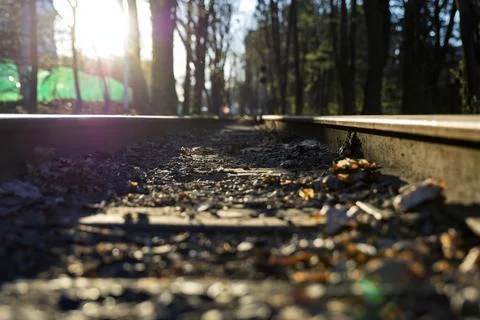 A close-up shot of parallel train tracks, focus on metal rails and wooden sle Stock Photos