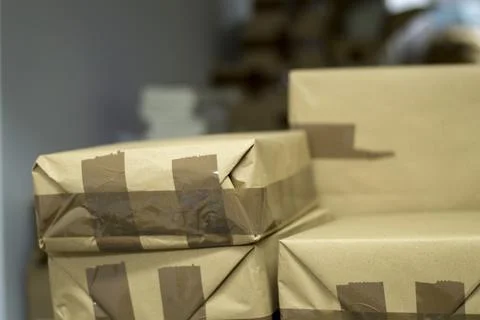 Close up shot of a parcel boxes made of craft paper with brown duct tape Stock Photos