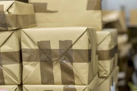 Close up shot of a parcel boxes made of craft paper with brown duct tape 스톡 사진