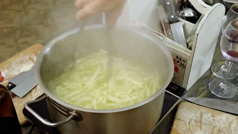 Close-up shot of pasta boiling in a pot on the electric stove. 4K Stock Footage 91401165