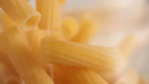 Close up shot of pasta falling into a jar in slow motion Stock Footage 156810264