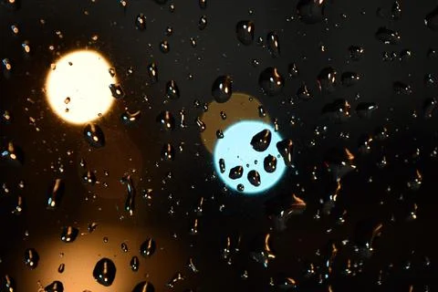 Close-up shot of a patch of reflected light on wet glass. Stock Photos