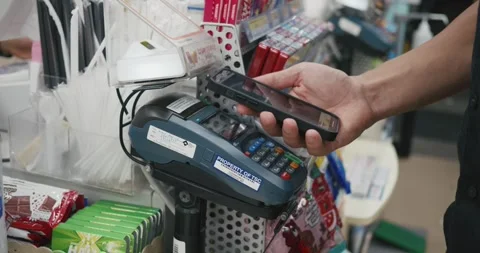Close up shot of pay by smartphone on pos terminal at grocery store. E-money Stock Footage 250729667