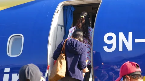 Close up shot of people getting inside an airplane door of Buddha Airlines. Stock Footage 281316156