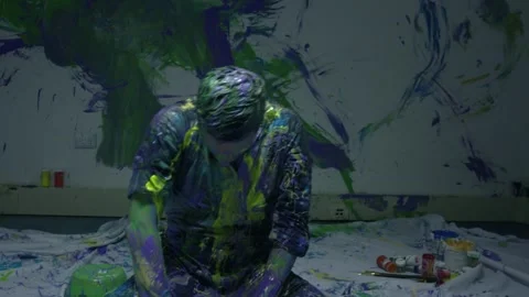 Close shot of Performing art of a dancing man bathed in colored paint. Stock Footage 255352803