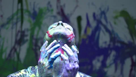 Close up shot of Performing art of a dancing man bathed in colored paint. Stock Footage 255352851