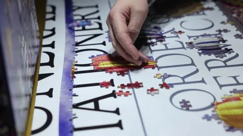 Close-up shot of a person finding the jigsaw pieces that join together Stock Footage 294151851