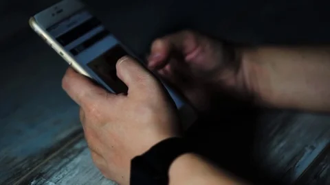 Close up shot of person hands that browsing news on smartphone. Stock Footage