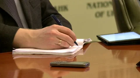 Close up shot of a persons hand writing something down at a meeting Stock Footage 49443393
