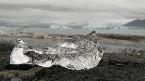 Close-up shot of a piece of ice lying on the beach Stock Footage 114885044