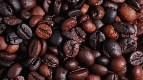 Close up shot of pile of rotating roasted coffee beans Stock Footage 269865144
